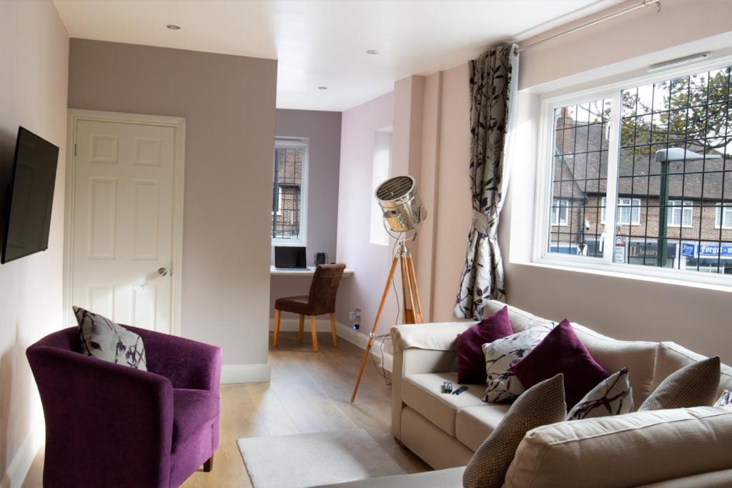 a living room with a couch and a window at KingsHouse In Cheam Village in Cheam