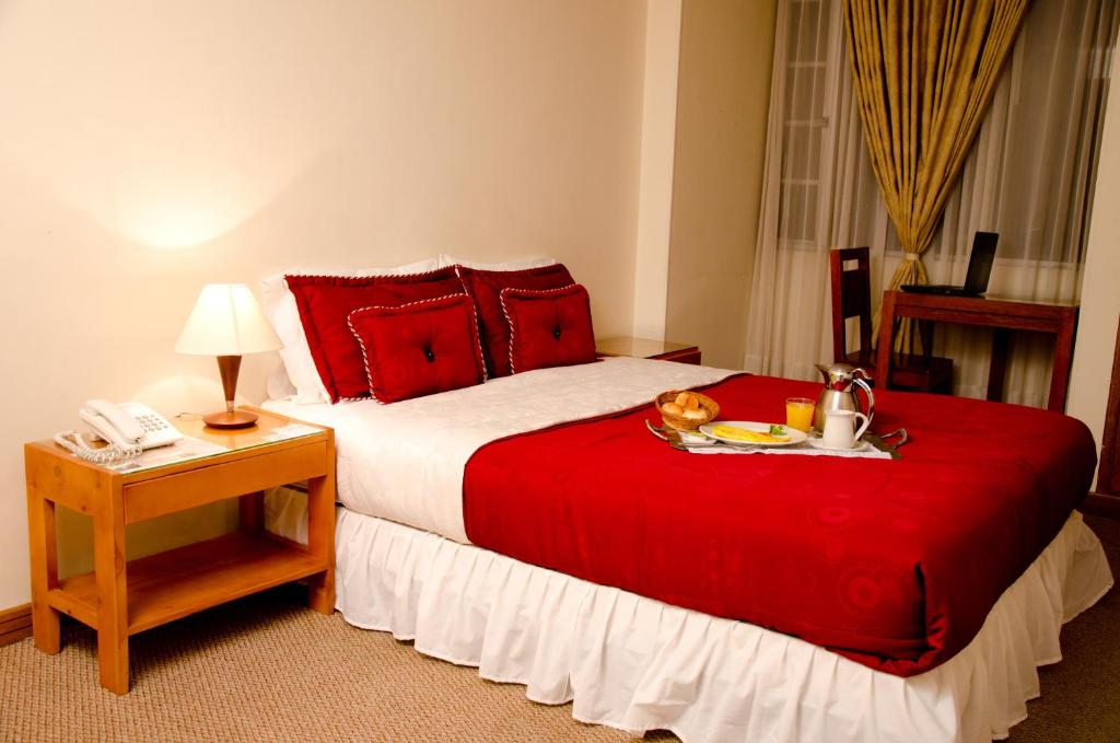 En eller flere senge i et værelse på Hotel Casa La Riviera