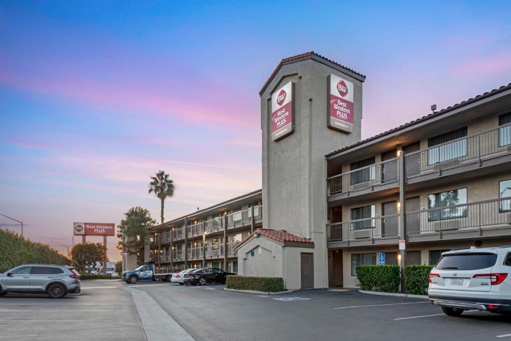 a building with cars parked in a parking lot at Best Western Plus Executive Inn in Rowland Heights