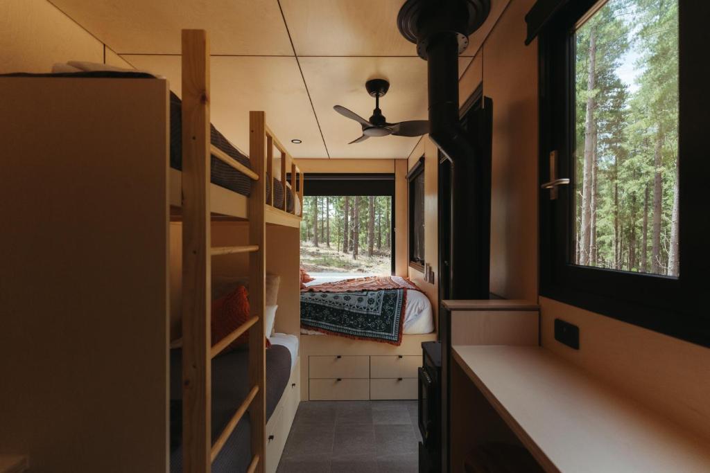 a small room with bunk beds and a window at CABN Kuitpo Forest in Kuitpo
