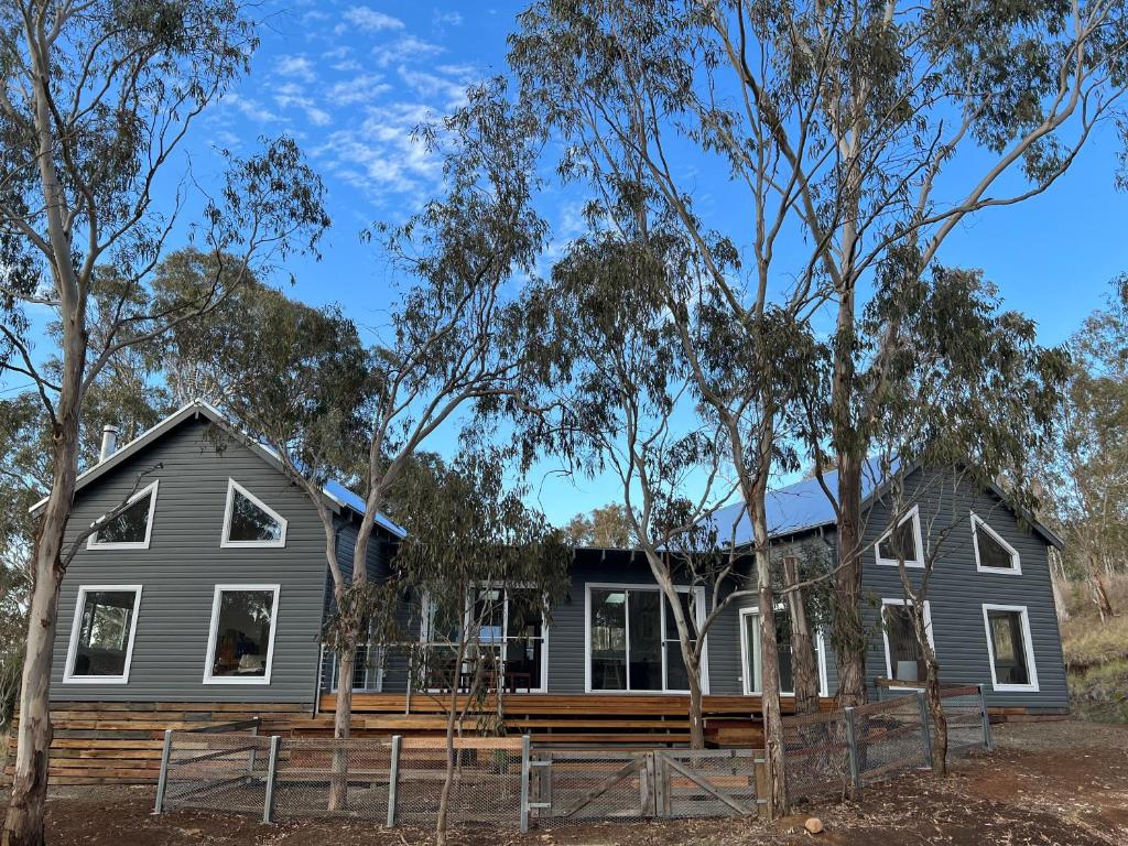 a home in the bush with trees in the foreground at Summit House Armidale - 2 or 4 Bedrooms in Armidale