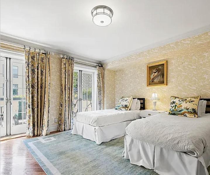 a bedroom with two beds and a large window at E 60s Townhouse comfortable, quiet, easy to manage 3 bedrooms w gym that can also be a 4th bedroom in New York