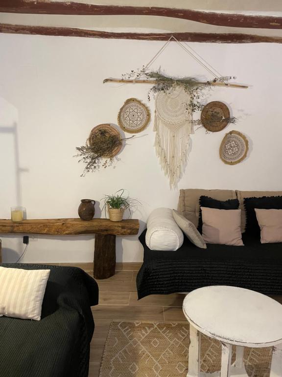 a living room with a couch and a table at El Mirador de Benialfaqui, apartamento Els Olivers 