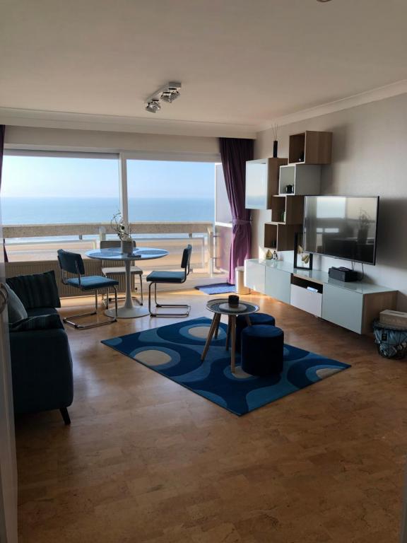 a living room with a view of the ocean at Enjoy@sea in Ostend