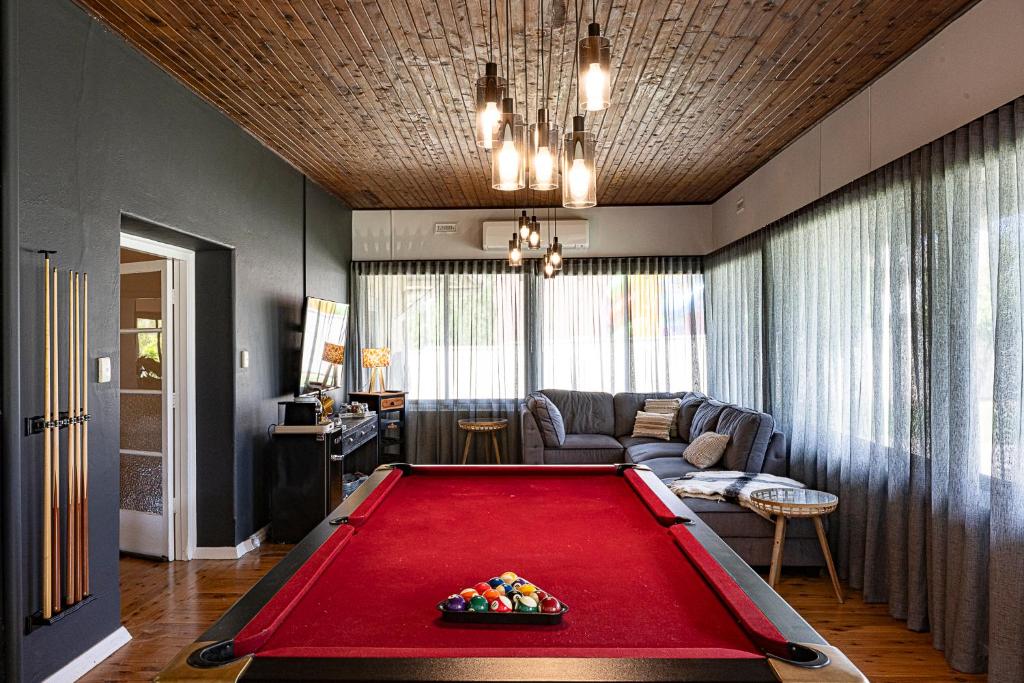 a large red pool table in a living room at Fairleys of Corowa in Corowa