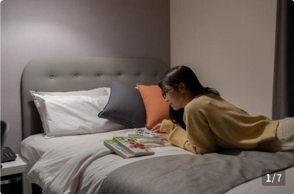 Postel nebo postele na pokoji v ubytování Ggumgguda Hotel