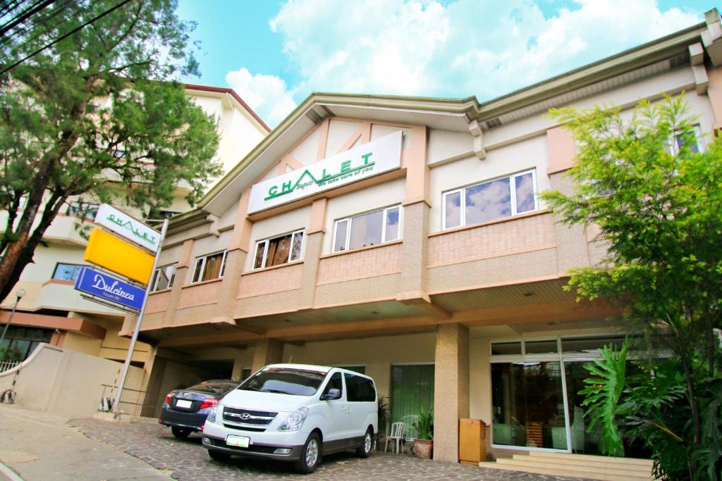 a white van parked in front of a building at Chalet Baguio in Baguio