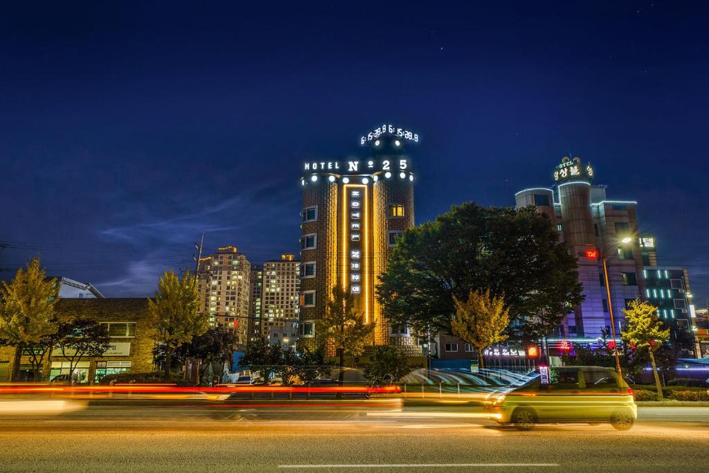 a city at night with a building with lights at Gongju No 25 Hotel in Gongju