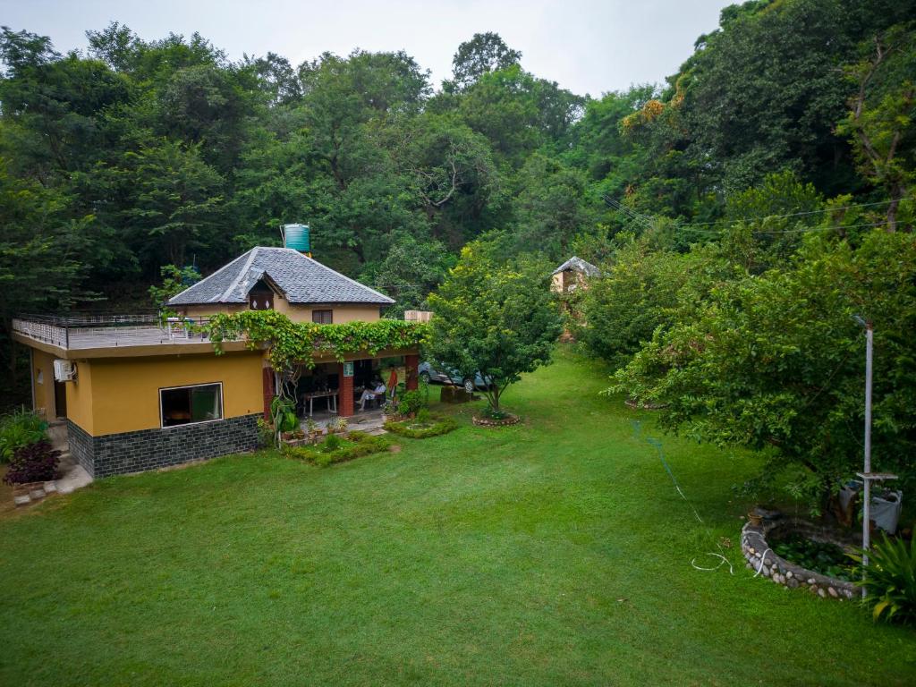 an aerial view of a house with a yard at Raadballi Retreat in Kangra
