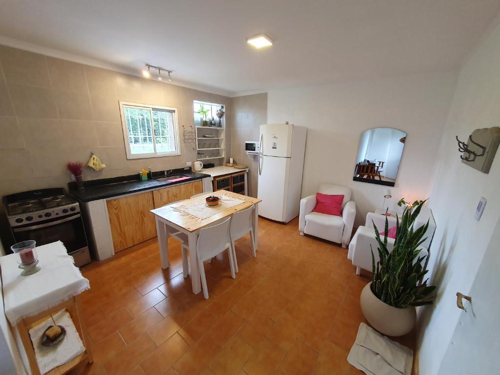 uma cozinha com uma mesa e um frigorífico branco em Casa de Campo Establecimiento La Leticia em Rafaela
