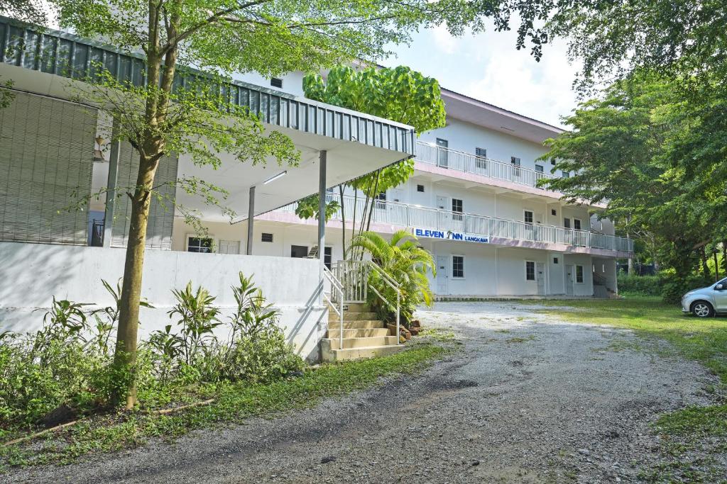 an empty parking lot in front of a building at OYO 90879 Eleven Inn in Kuah