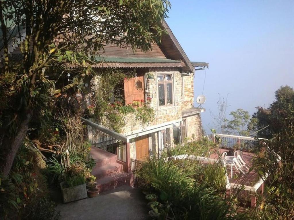 an old house with plants on the side of it at The English Cottage Darjeeling in Darjeeling