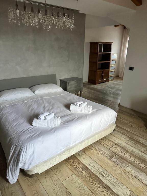 a bedroom with a bed with two towels on it at Attico centro storico in Pavia