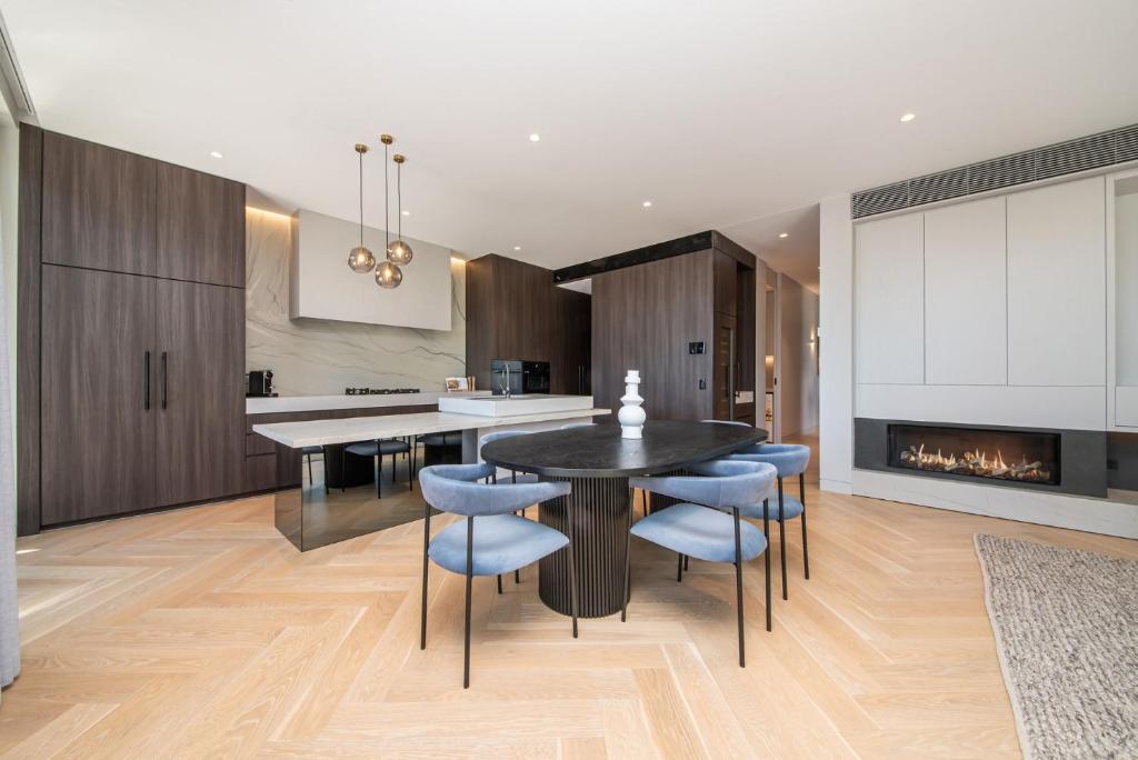 a kitchen with a table and chairs and a fireplace at The Gratis Deepdene in Melbourne