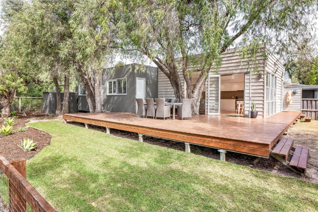 a wooden deck in the backyard of a house at On The Bay in Quindalup