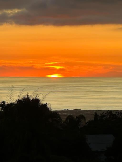 a sunset over the ocean with the sun in the sky at Rev' Horizon in Le Tampon