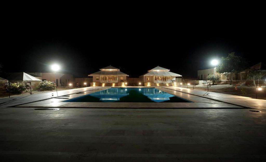 ein großer Swimmingpool in der Nacht mit einem Gebäude in der Unterkunft Ekanta Resort in Sām