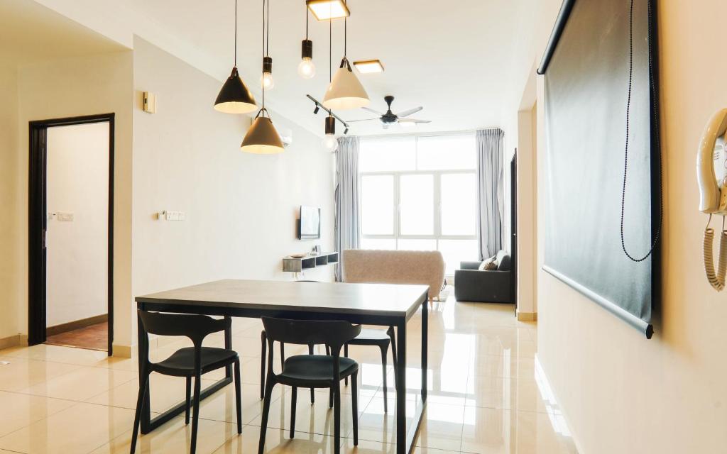 a kitchen and dining room with a table and chairs at Boulevard Service Apartment KL by Airhost in Kuala Lumpur