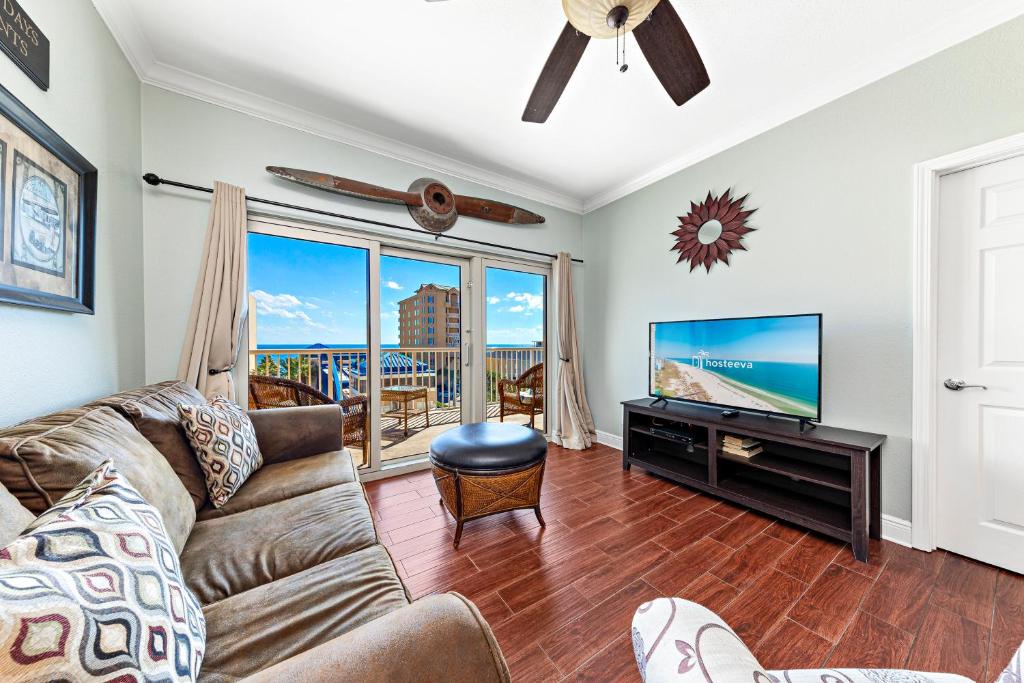 a living room with a couch and a flat screen tv at Crystal Tower 404 in Gulf Shores