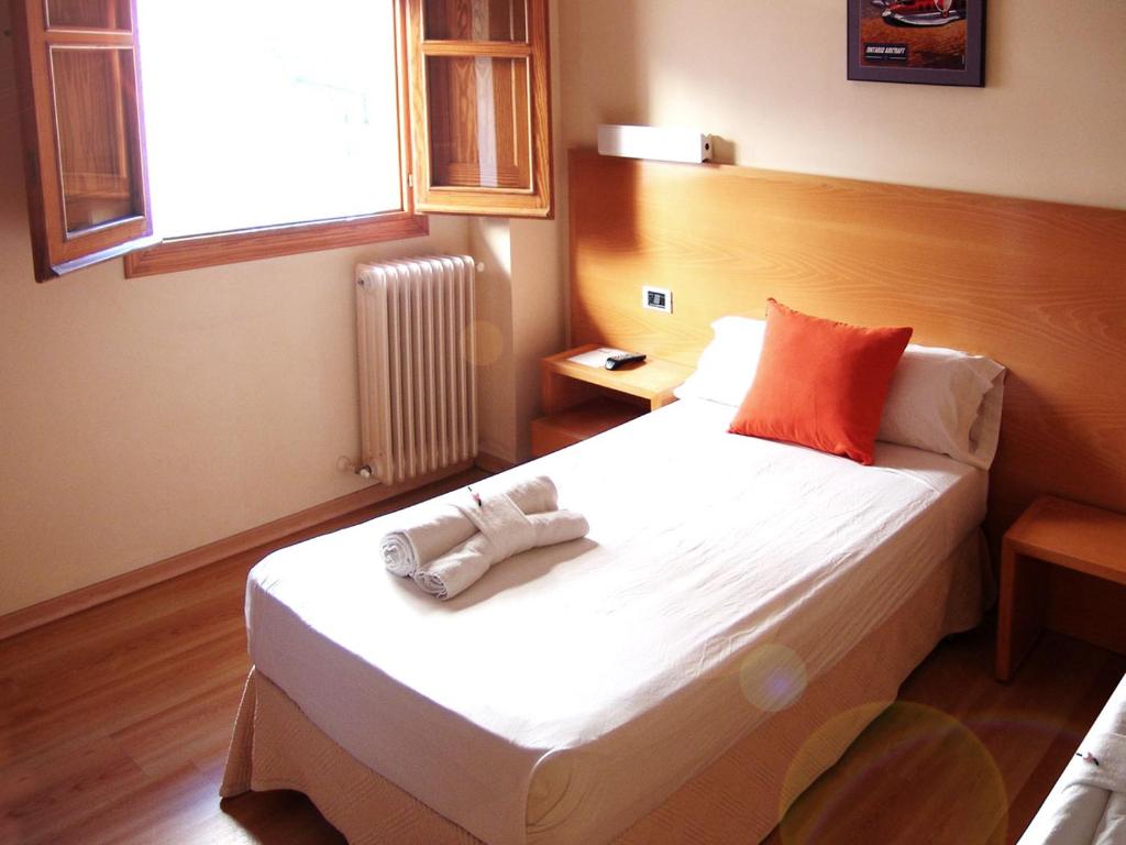 a bedroom with a bed with a towel on it at Hotel La Tinensa in Puebla de Benifasar