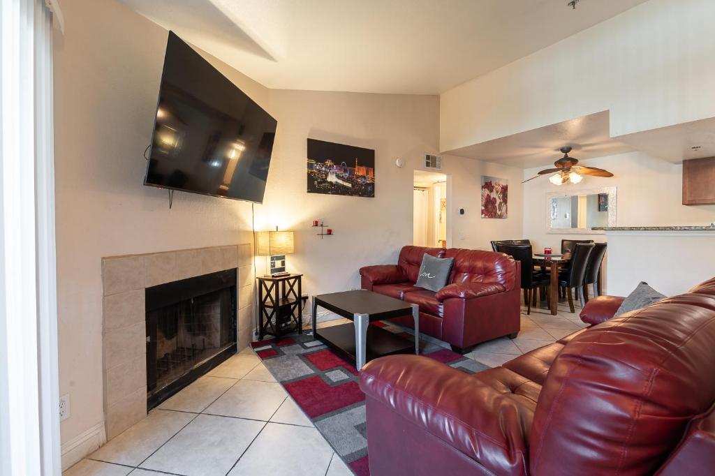 a living room with a couch and a fireplace at Stylish, Cozy 2BR,2BA Condo near Rio, Vegas Luxury in Las Vegas