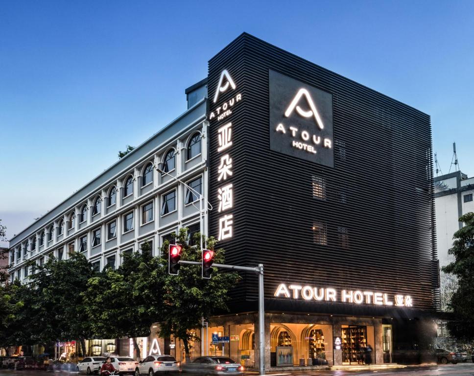 a large black building with a group hotel on it at Atour Hotel Guangzhou Huadu Square in Huadu