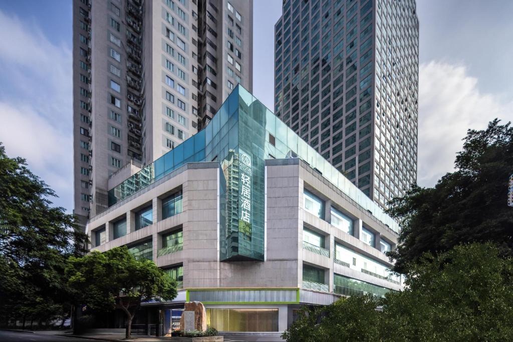 a building with two tall buildings in a city at Atour Light Hotel Fuzhou Sanfang Qixiang in Fuzhou