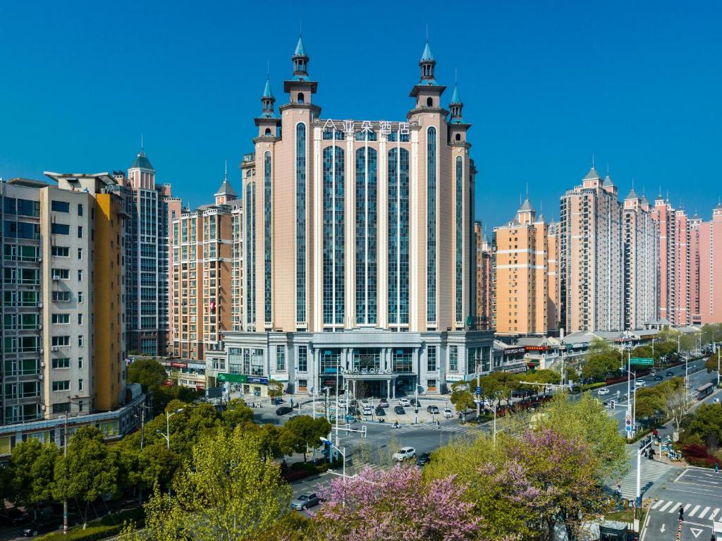 a large building with two towers in a city at Atour Hotel Hefei Pearl Plaza Huijin Business Center in Hefei