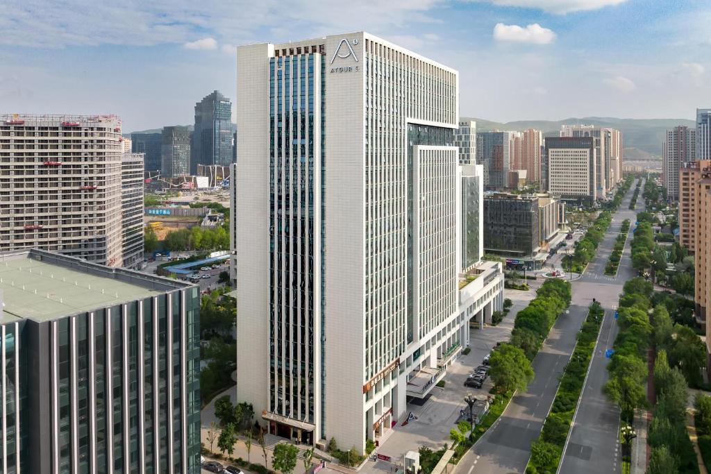 an aerial view of a tall building in a city at Atour S Hotel Xining Haihu New District SDIC Plaza in Xining