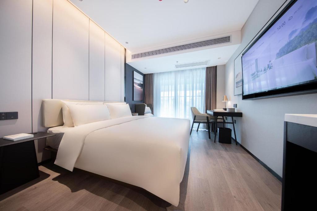 Postel nebo postele na pokoji v ubytování Atour Hotel Zhaoqing Qixingyan