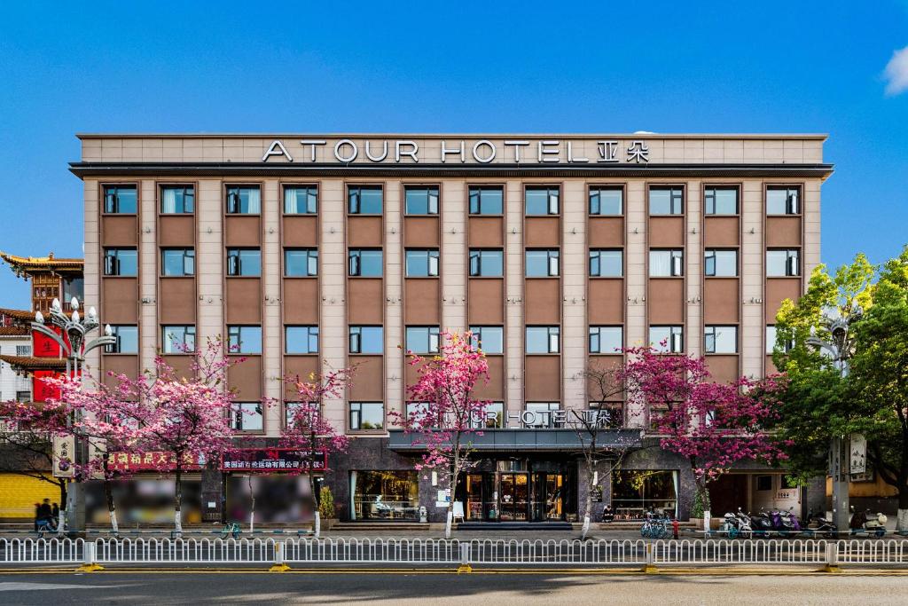 duży budynek z znakiem na górze w obiekcie Atour Hotel Kunming Cuihu w mieście Kunming