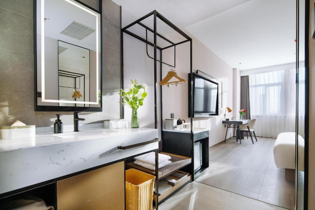 a bathroom with a sink and a mirror at Atour Hotel Shenyang Zhongshan Plaza in Shenyang