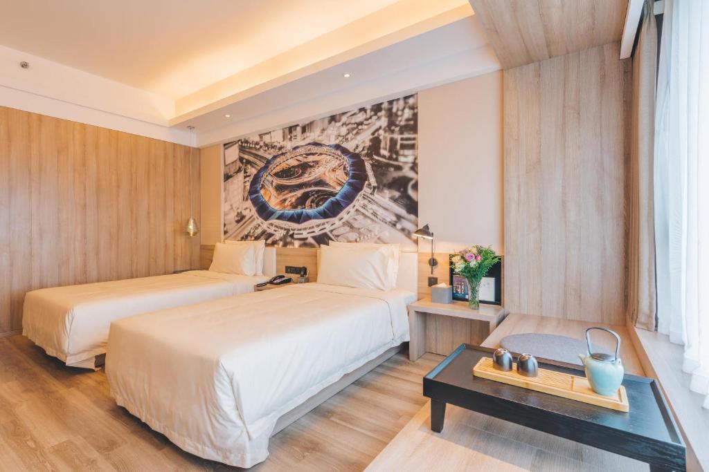 Postel nebo postele na pokoji v ubytování Atour Hotel Shanghai Wujiaochang Dabaishu
