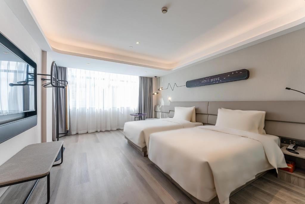 Postel nebo postele na pokoji v ubytování Atour Light Hotel Shanghai Xujiahui Jiaotong University