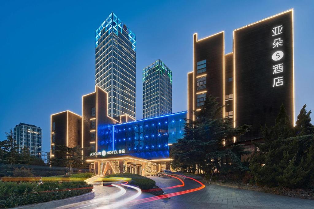 a group of tall buildings in a city at night at Atour S Hotel Xinghai Square in Dalian