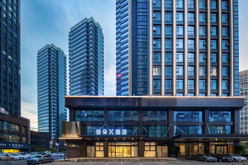 a view of a building with two tall buildings at Atour X Hotel Hangzhou Binjiang Jiangnan Avenue in Hangzhou