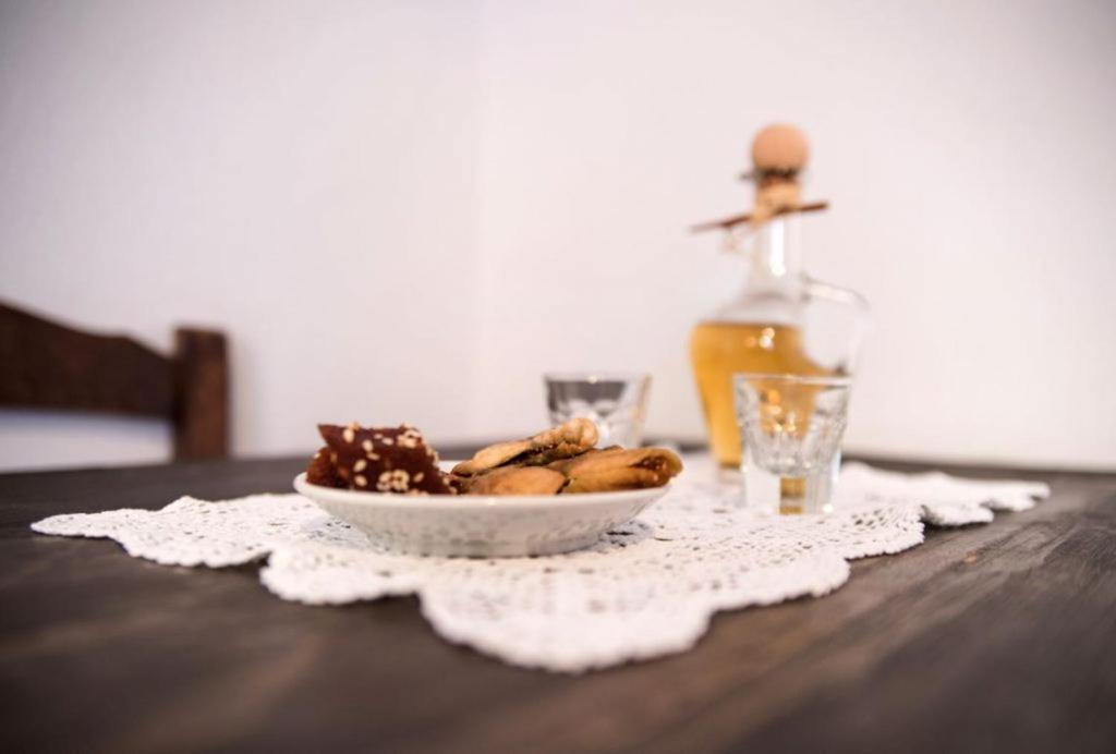 a bowl of cookies on a table with a bottle of oil at Abramis Rooms in Mitáta