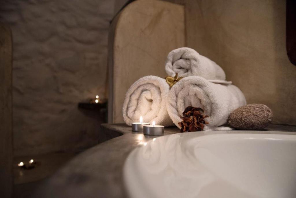 a bathroom with towels on the edge of a sink at Abramis Rooms in Mitáta