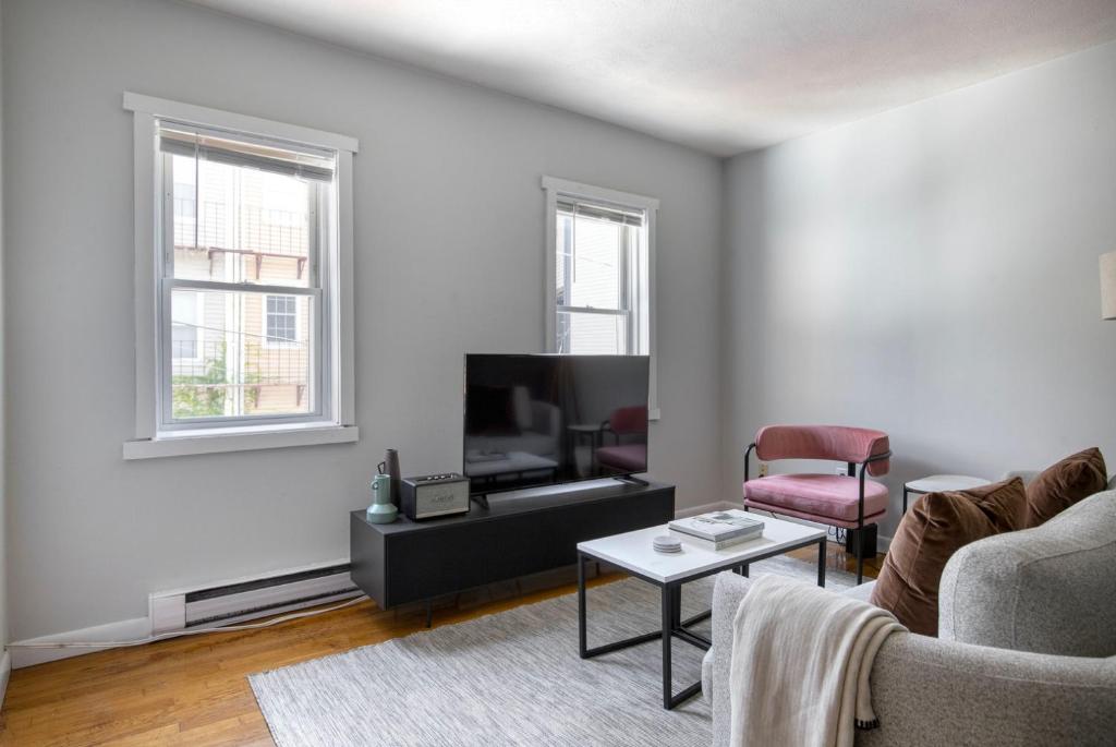 a living room with a couch and a tv at South Boston 2br w building wd nr seaport BOS-915 in Boston