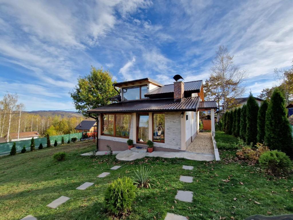 a small house in the middle of a yard at Mountain House Brutusi 17 Bjelasnica Trnovo BIH in Trnovo