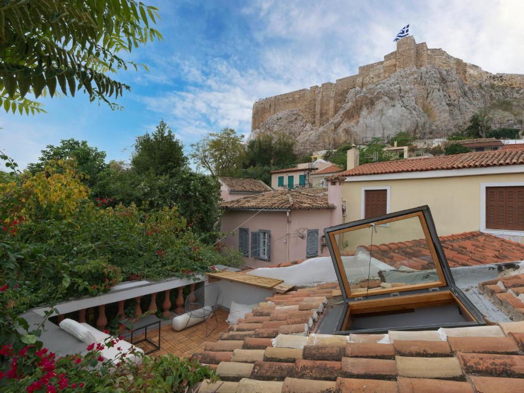 a mirror on the roof of a house with a mountain at Live at the Acropolis shadow - under super scenic Anafiotika in Athens