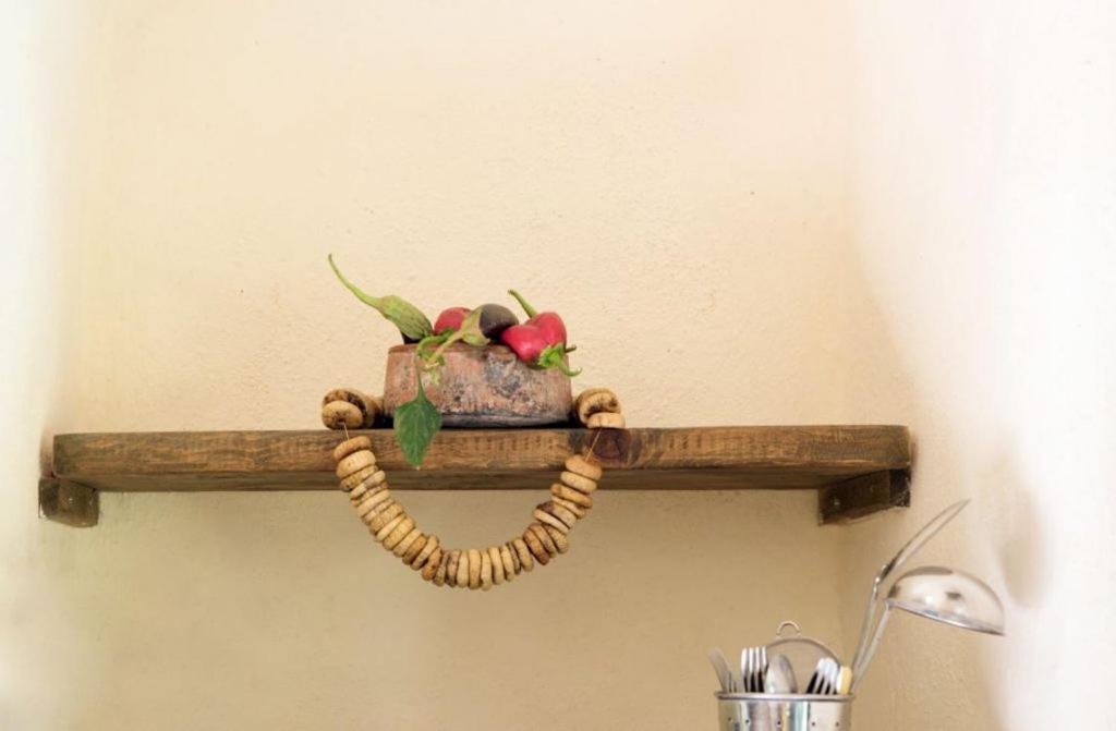 a wooden shelf with a fish ornament on a wall at Abramis Rooms in Mitáta