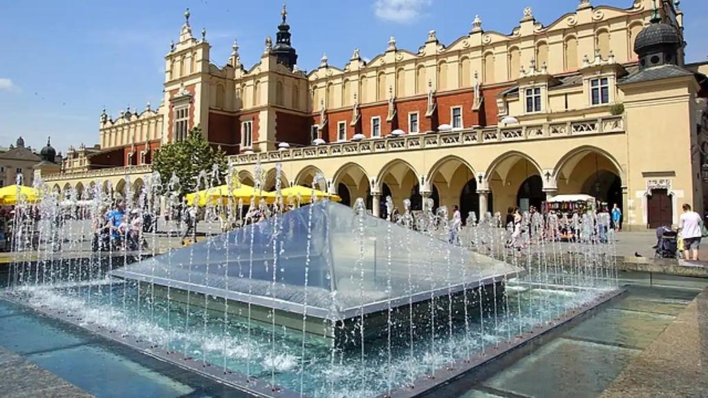 a water fountain in front of a building at 8 min to Castel & Main Square in Krakow