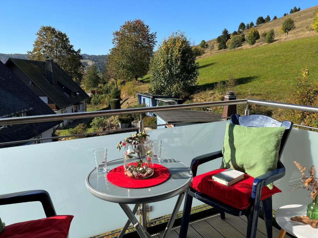 a table and chairs on a balcony with a view at Apartment Schwarzwaldblick III by Interhome in Bernau im Schwarzwald