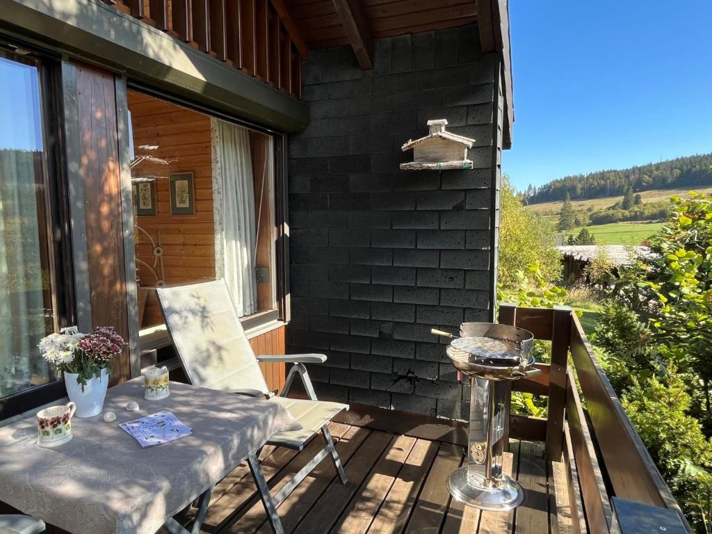 a patio with a table and a grill on a balcony at Holiday Home Rechbergblick - BEU302 by Interhome in Bernau im Schwarzwald
