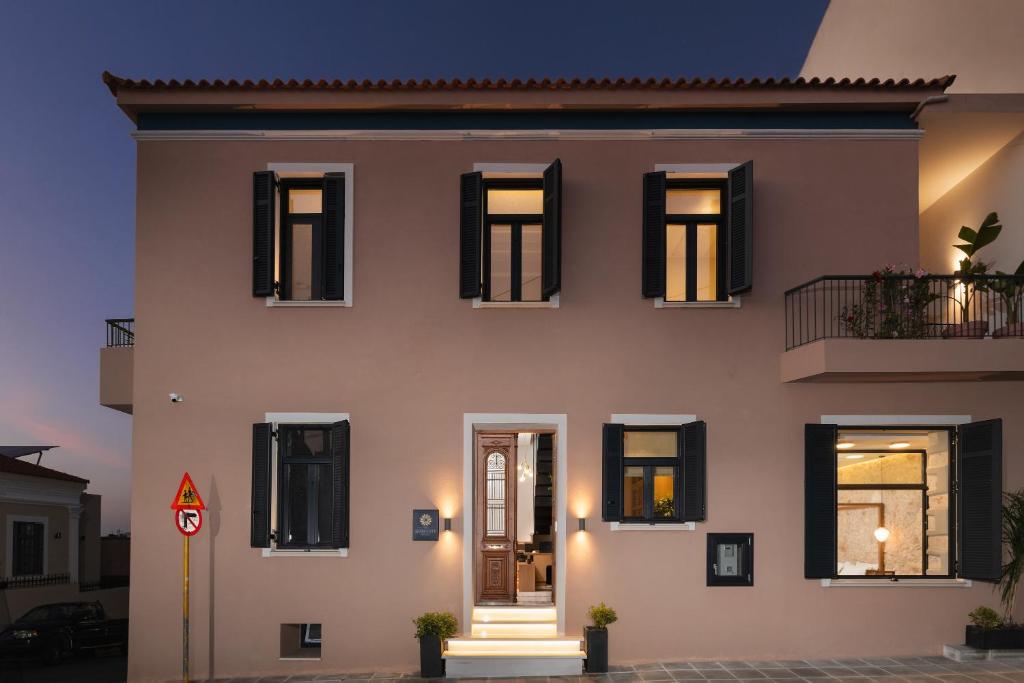 a large white house with black windows at The Alma City Hotel in Chania Town