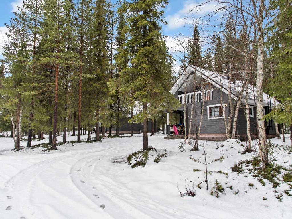a house in the snow with a road in front at Holiday Home Kaltiotievantie 2 mökki 2 by Interhome in Ylläsjärvi