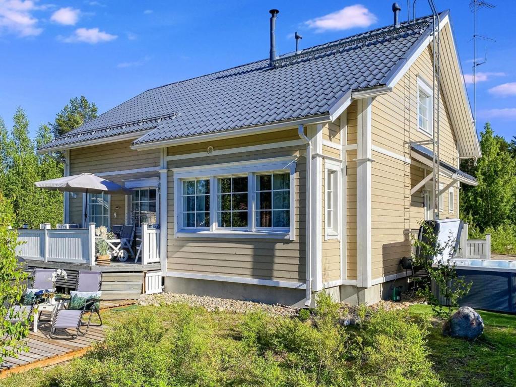 een tiny house met een terras en een zwembad bij Holiday Home Villa adalmina by Interhome in Hattusaari