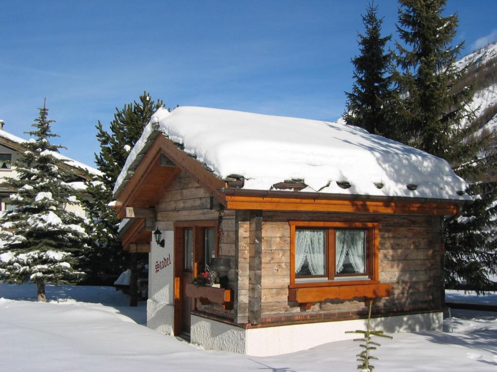 a small log cabin with snow on the roof at Chalet Häuschen Stadel by Interhome in Saas-Grund