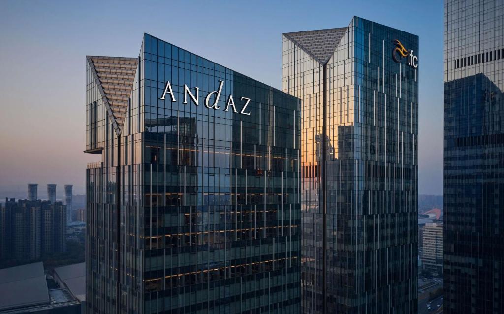 a tall glass building with the amazon sign on it at Andaz Nanjing Hexi in Nanjing